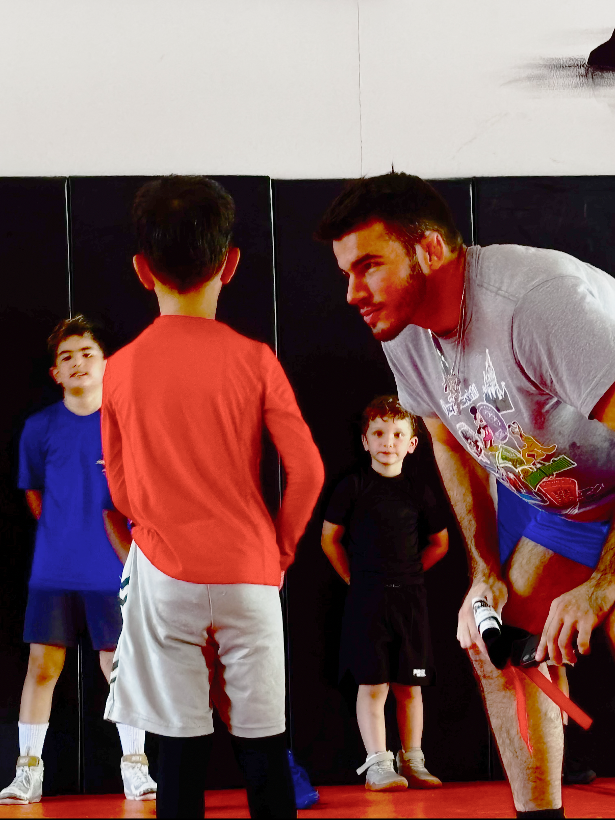 Coach Nate drilling technique with a youth wrestler